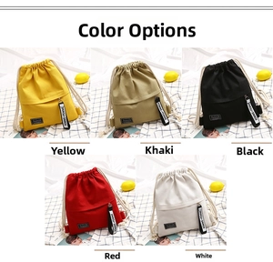 Detailed view of canvas drawstring backpacks in yellow, khaki, black, red, and white colors