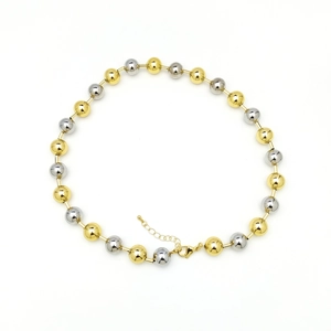 Close-up of dual-tone gold and silver beaded chain with lobster clasp and extension link