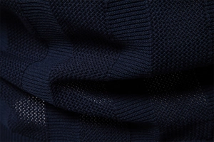 Macro shot of breathable dark blue knit mesh fabric texture for men's summer polo shirts