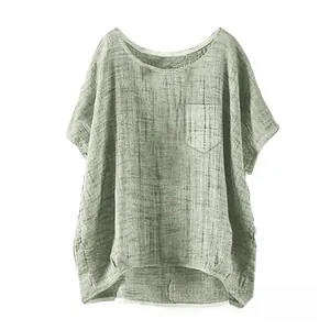 Detail of olive green linen blouse featuring a chest pocket and round neckline