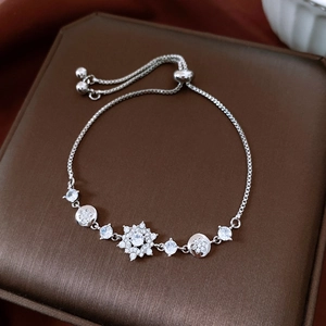 Detail of silver box chain bracelet with adjustable slide clasp and zircon star charms