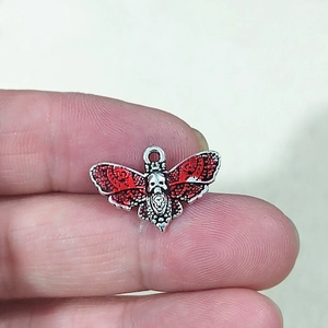 Gothic skull butterfly pendant with red heart details in silver-tone alloy finish