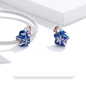Macro shot of a 925 silver Santa charm with navy enamel and snowflakes on a bracelet