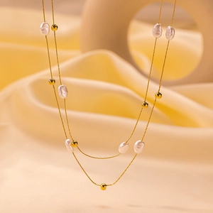 Double-layered gold chain necklace with irregular pearls and small beads for women