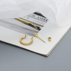 Detailed view of 925 silver gold-plated stud earring and mini hoop with pave zircon