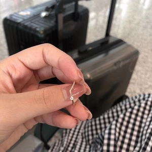 Minimalist S925 sterling silver V-shaped ring with a sparkling solitaire diamond on a finger