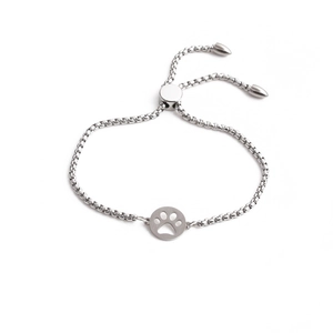 Detail of adjustable silver steel box chain bracelet featuring a cute paw print charm