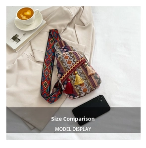Close-up of bohemian woven crossbody bag with colorful tassels on a beige blazer