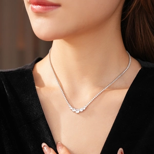 Silver zirconia pendant necklace worn on model neck for elegant jewelry style