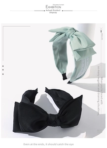 Detailed shot of bow headbands in mint green with lace and classic black fabric