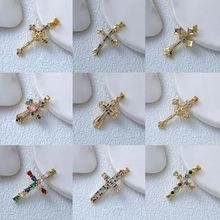 Detailed grid showing gold cross pendants with colorful cubic zirconia and gemstones