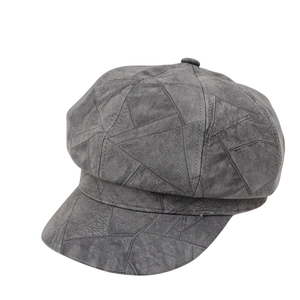 Grey newsboy cap featuring a geometric triangle pattern in suede finish on white background