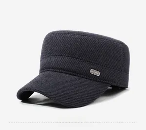Detail of wool cadet cap featuring twill fabric texture and silver metal brand badge