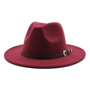 Detail of burgundy wool fedora hat featuring a slim leather band and silver carved buckle