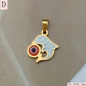 Detailed close-up of a golden evil eye heart pendant with sparkling white rhinestones