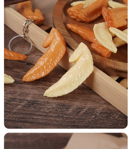 Macro shot of realistic resin chicken wing tip pendants with detailed skin texture