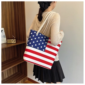 Close-up of large canvas tote bag featuring American flag print and rope handles