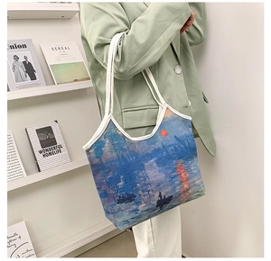 Lifestyle view of Monet Sunrise Impression oil painting print on a canvas tote bag