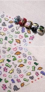 Detail of 3D embossed cartoon dinosaur nail stickers with colorful matte texture