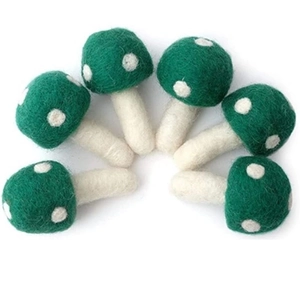 Handmade green wool felt mushroom accessories with white polka dots for DIY crafts