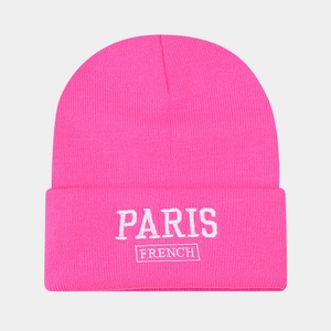 Detail of hot pink ribbed beanie featuring white Paris French embroidery texture