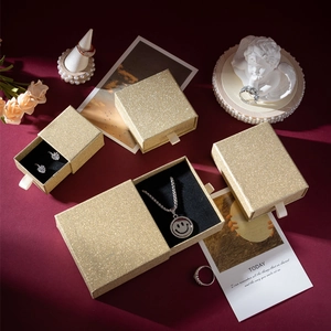 Detailed view of golden glitter jewelry gift boxes in various sizes for rings and necklaces
