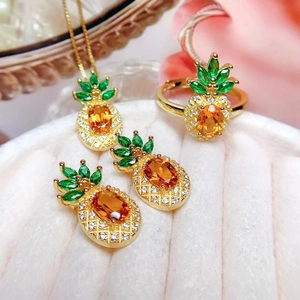 Creative pineapple jewelry set with orange gemstones and green crystals on gold base