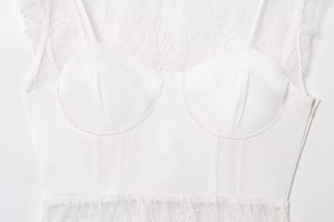 Detailed view of white lace patchwork bustier top featuring intricate floral mesh textures