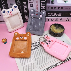 Detail of cute animal plush card holders with transparent slots and metal keychains