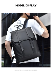 Outdoor view of a man wearing a black leather backpack with double strap flap design