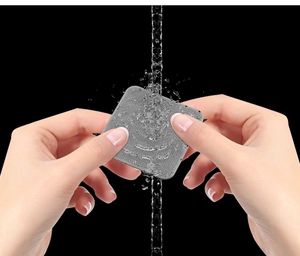 Water-washable non-slip sofa cushion gripper pad being rinsed under flowing water