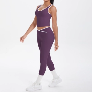 Detail view of purple yoga set featuring cross waist leggings and contrast piping