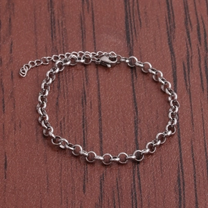 Close-up of stainless steel chain bracelet with lobster clasp and extension chain