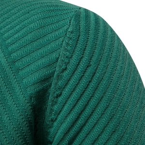 Close-up of shoulder seam and fine rib knit texture on dark green cotton sweater