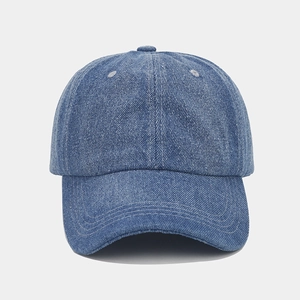 Detailed close-up of blue denim baseball cap showing premium stitching and fabric texture