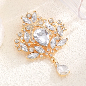 Detailed macro view of a golden flower brooch with sparkling crystal rhinestones
