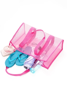 Pink mesh beach tote bag with large capacity filled with vacation essentials