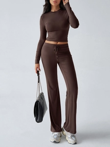 Detail of a dark brown two-piece Y2K tracksuit featuring long sleeves and drawstring pants