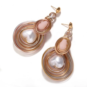Detailed view of handmade bohemian heart pearl earrings with spiral wire wrapping