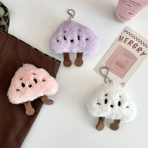 Close-up of three cute plush cloud charms in pink, purple, and white for bags