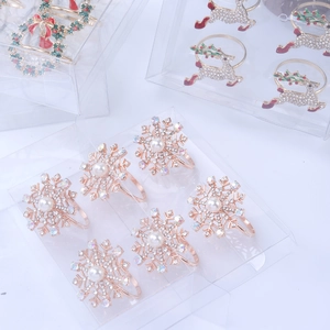 Detail of Christmas napkin rings with snowflake and reindeer designs in a gift box