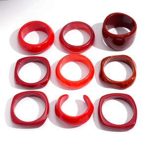 Set of nine irregular resin bangles in trendy dark red with glossy marble textures