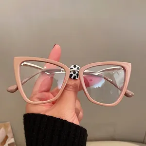 Pink cat-eye anti-blue light glasses with glossy finish and metal hinge details