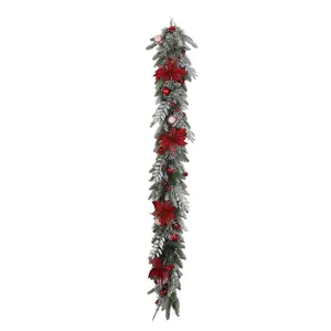 Christmas garland with red poinsettia flowers berries and flocked pine needles decor