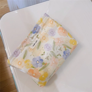 Macro detail of floral cotton fabric texture and simple wish label on the makeup bag