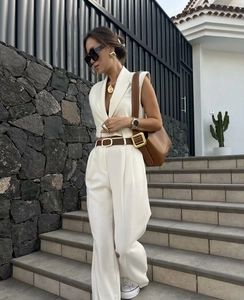 Chic white sleeveless waistcoat and high-waist wide-leg trousers suit with brown belt