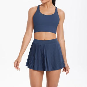 Detail of dark blue pleated tennis skirt and matching sports bra athletic set