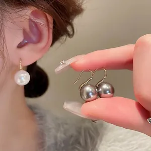 Elegant gold hook earrings with white and grey pearls for a minimalist luxury look