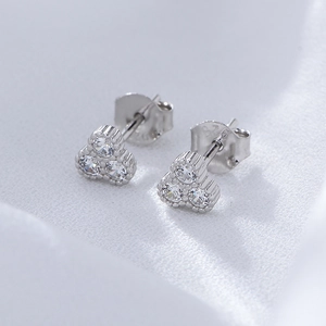 Macro shot of S925 silver three-petal flower studs with white cubic zirconia and 925 hallmark