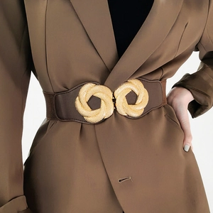 Close-up of brown elastic waist belt featuring a textured golden interlocking ring buckle